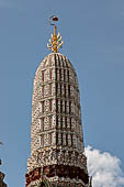 Bangkok Wat Arun - Detail of the spire of one of the four corner prangs with the golden crown at the peak. 